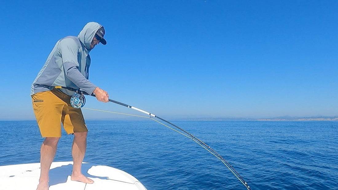 ALLSURF rod heavily bent while fighting a shark on fly tackle offshore.